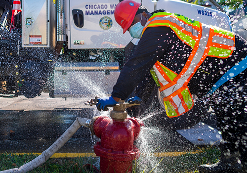 A Water Management employee fixing a fire hydrant