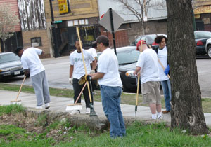 Several People Cleaning Streets with Brooms