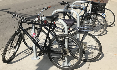 Bikes locked to inverted U racks.
