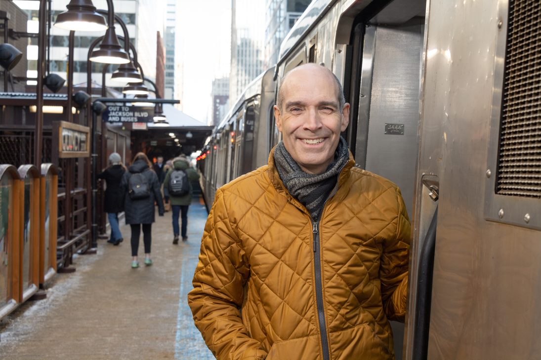 Geoffrey Baer stands in front of a CTA train